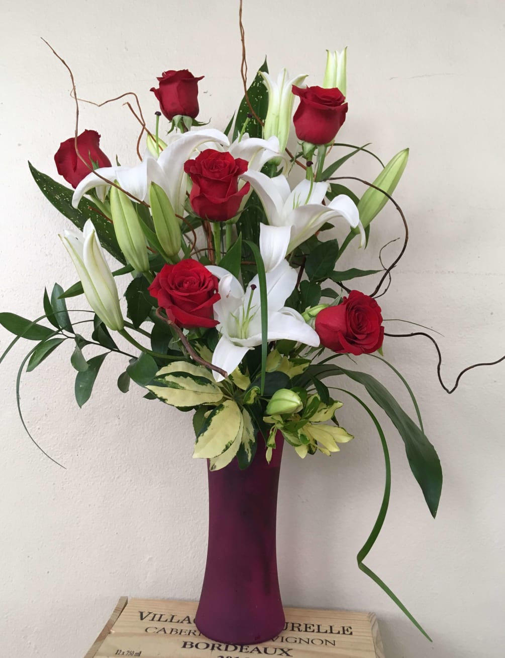 3 White Lilies , 6 Red Roses in pink glass vase 