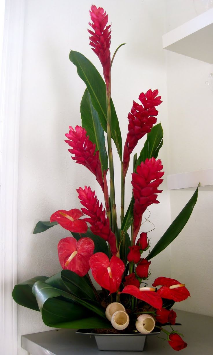 Fragrant stargazer lilies, tropical ginger, and exotic greens create an impressive display.