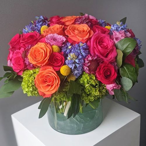 A luxurious bed of stunning and vibrant roses, hyacinth, hydrangea, scabiosa, spray