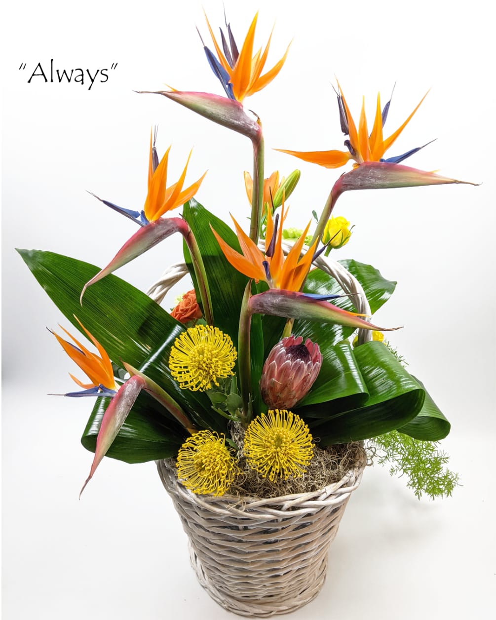Hand-crafted mixed flower bouquet in a basket.Each purchased arrangement may differ from