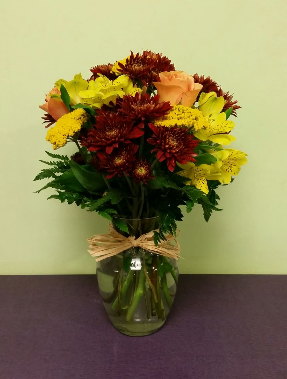This simple arrangement of fall colors and long lasting flowers will get