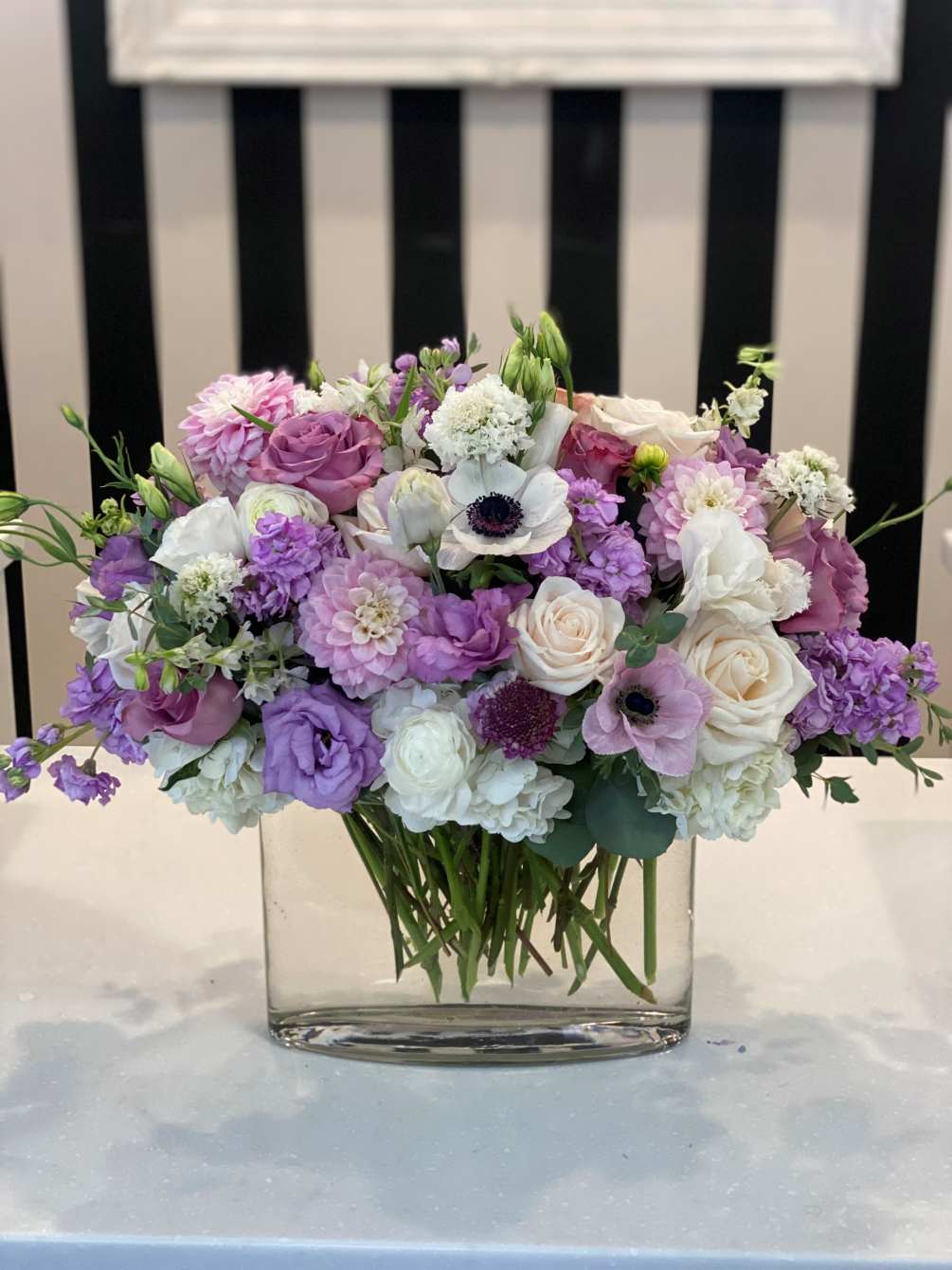 Beautiful, lush flower assortment with lavender and white premium flowers.