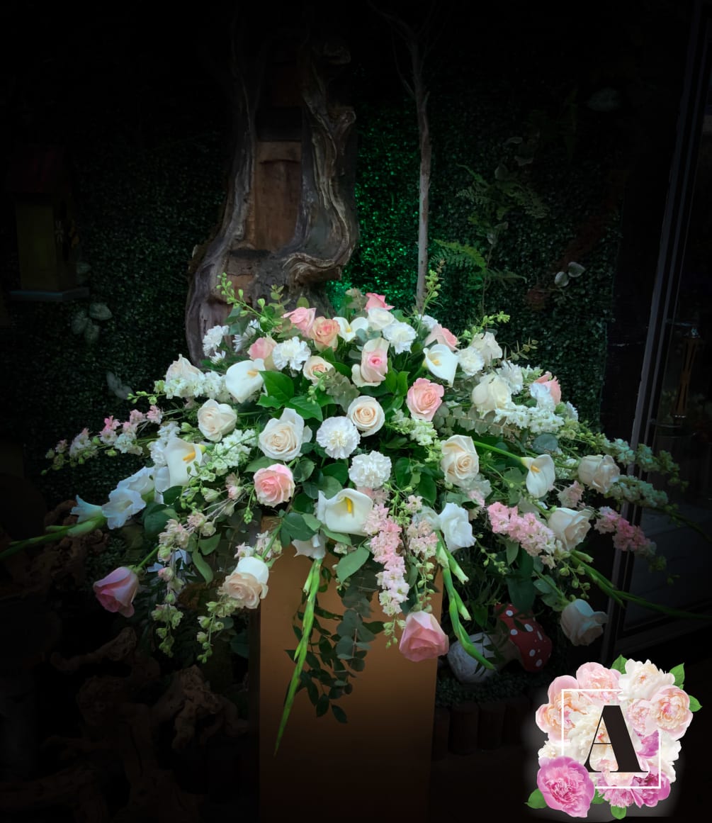 Grand casket topper with seasonal mix of beautiful flowers. Please let us