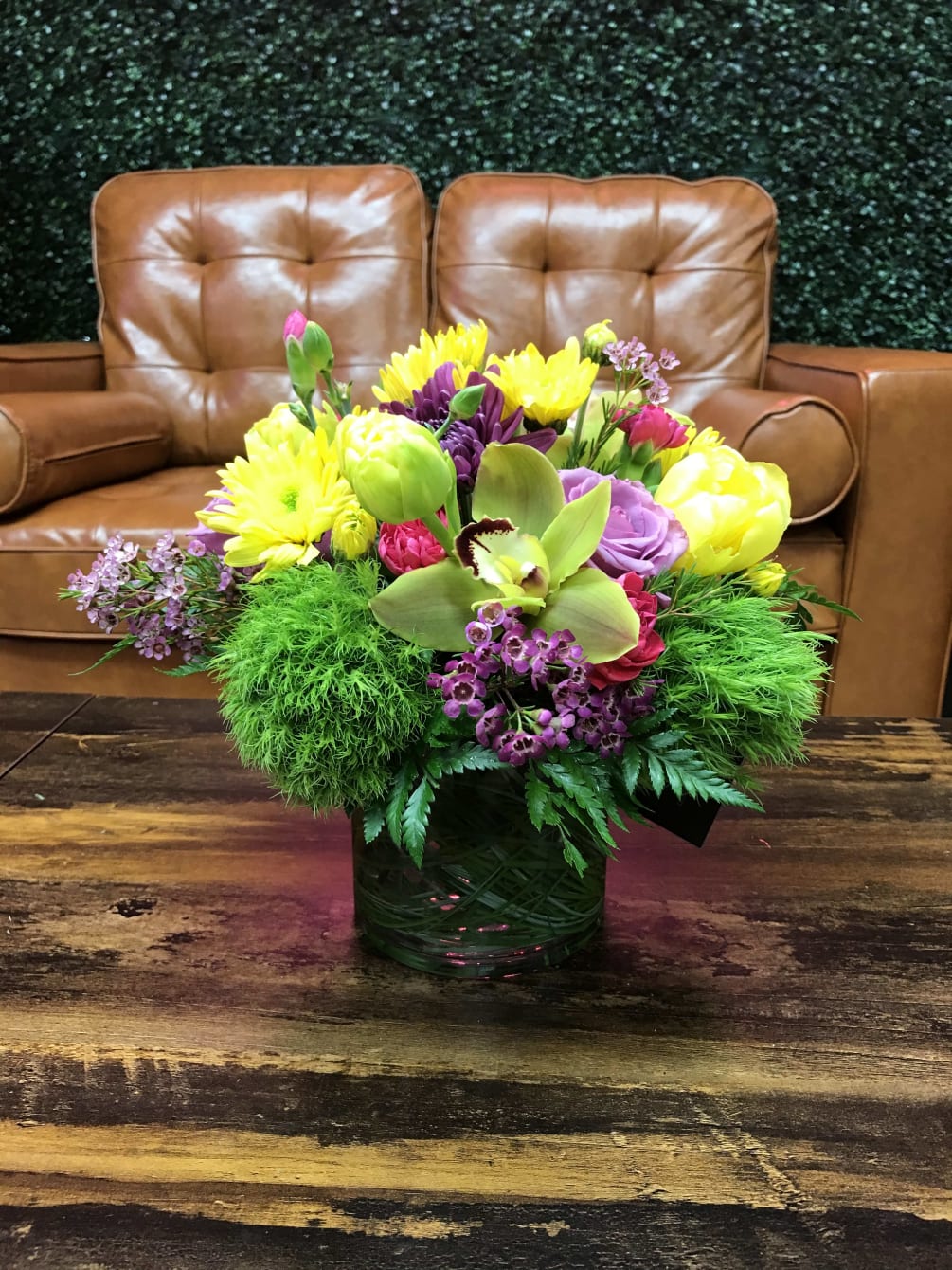 Orchids,roses, and a unique blend of seasonal flowers. Varieties and colors may