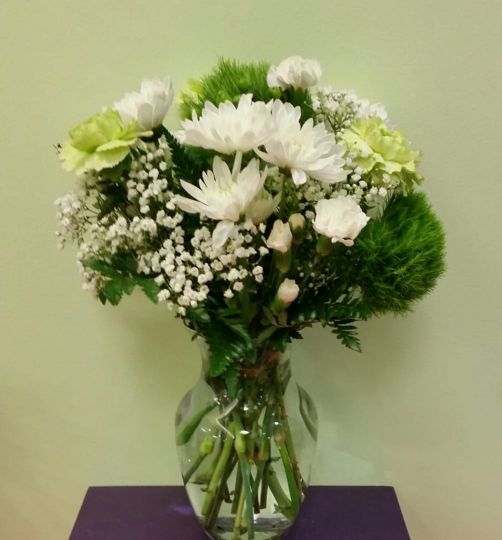 This simple green and white arrangement is perfect for any occasion. Celebrate
