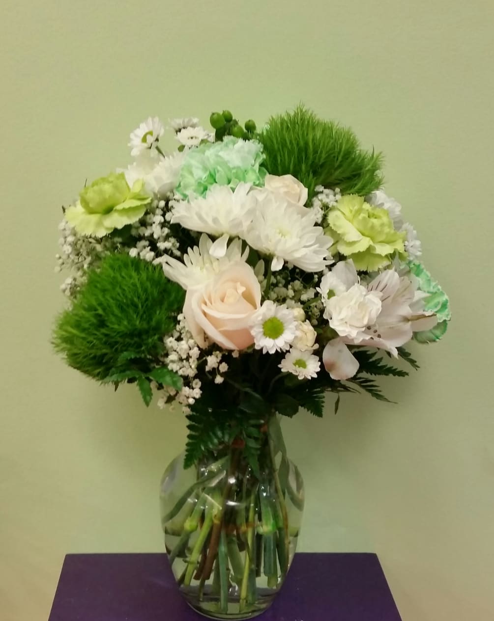 This is an exotic green and white arrangement that is filled with