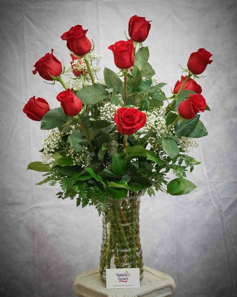 Beautiful vase arrangement designed with one dozen 70 cm red roses in