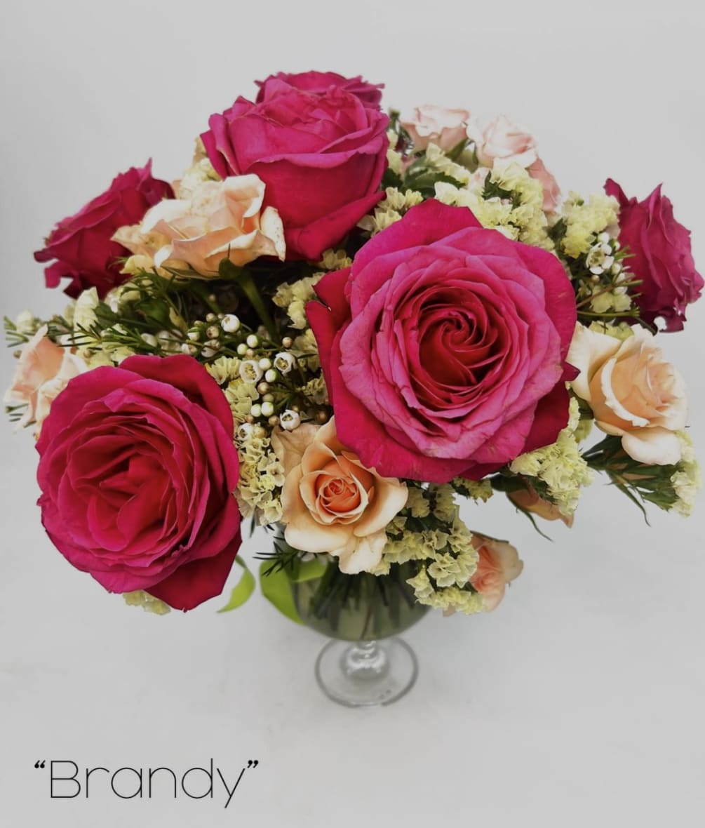 This bouquet is made with seasonal flowers in a brandy glass. If