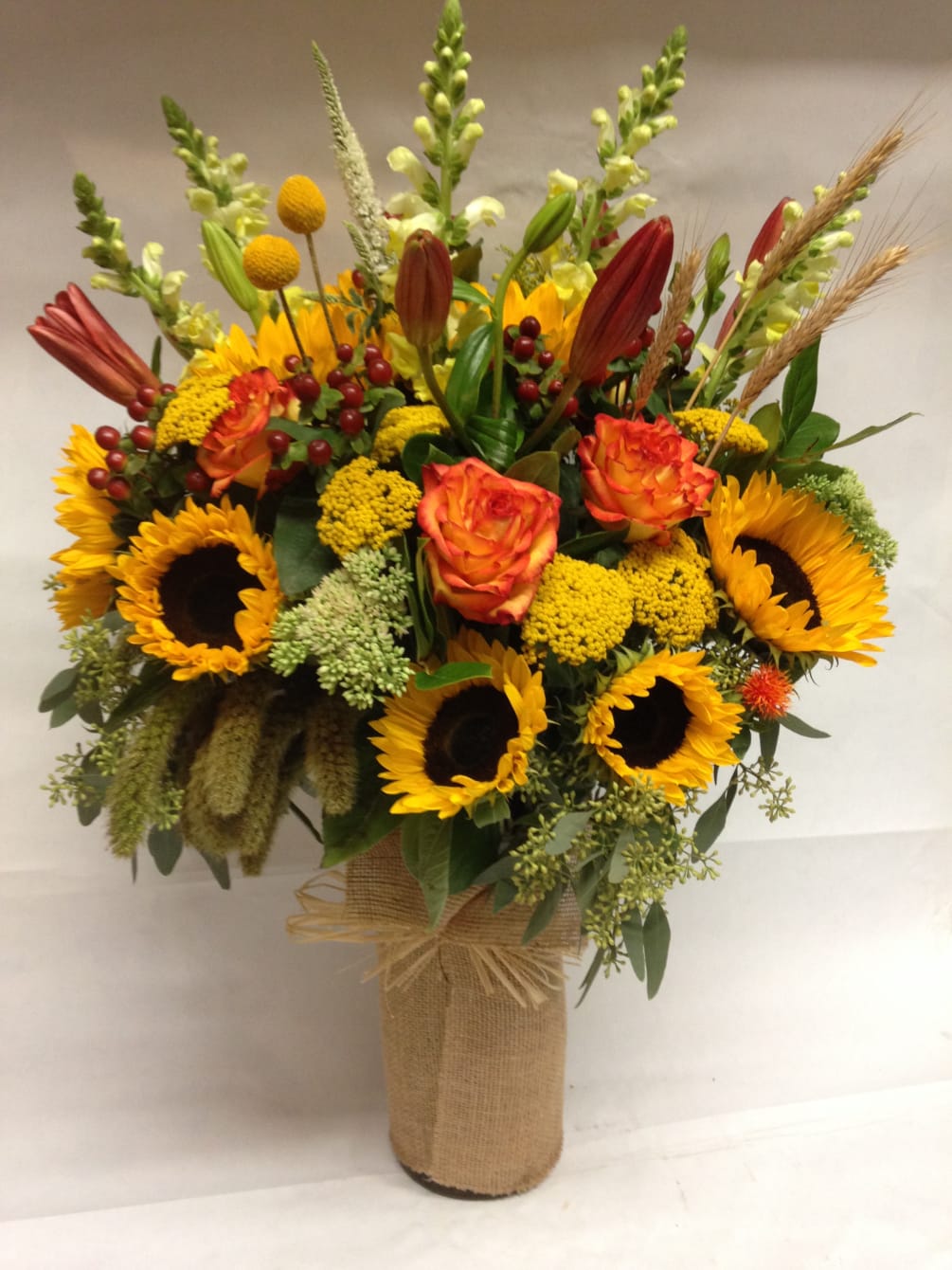 This arrangement comes complete with aziatic lilies, sunflowers, roses, hypericum, billy balls