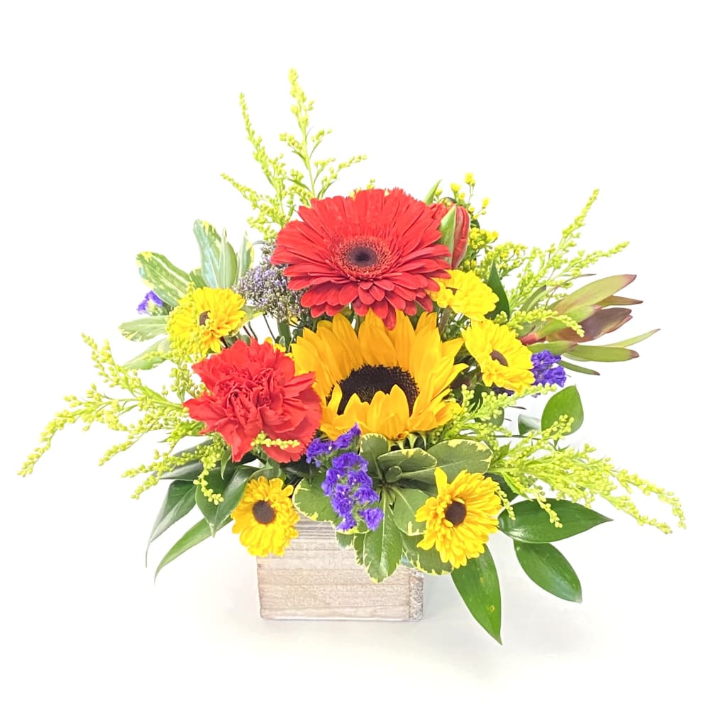Sunflowers paired with bright florals in a rustic wooden box