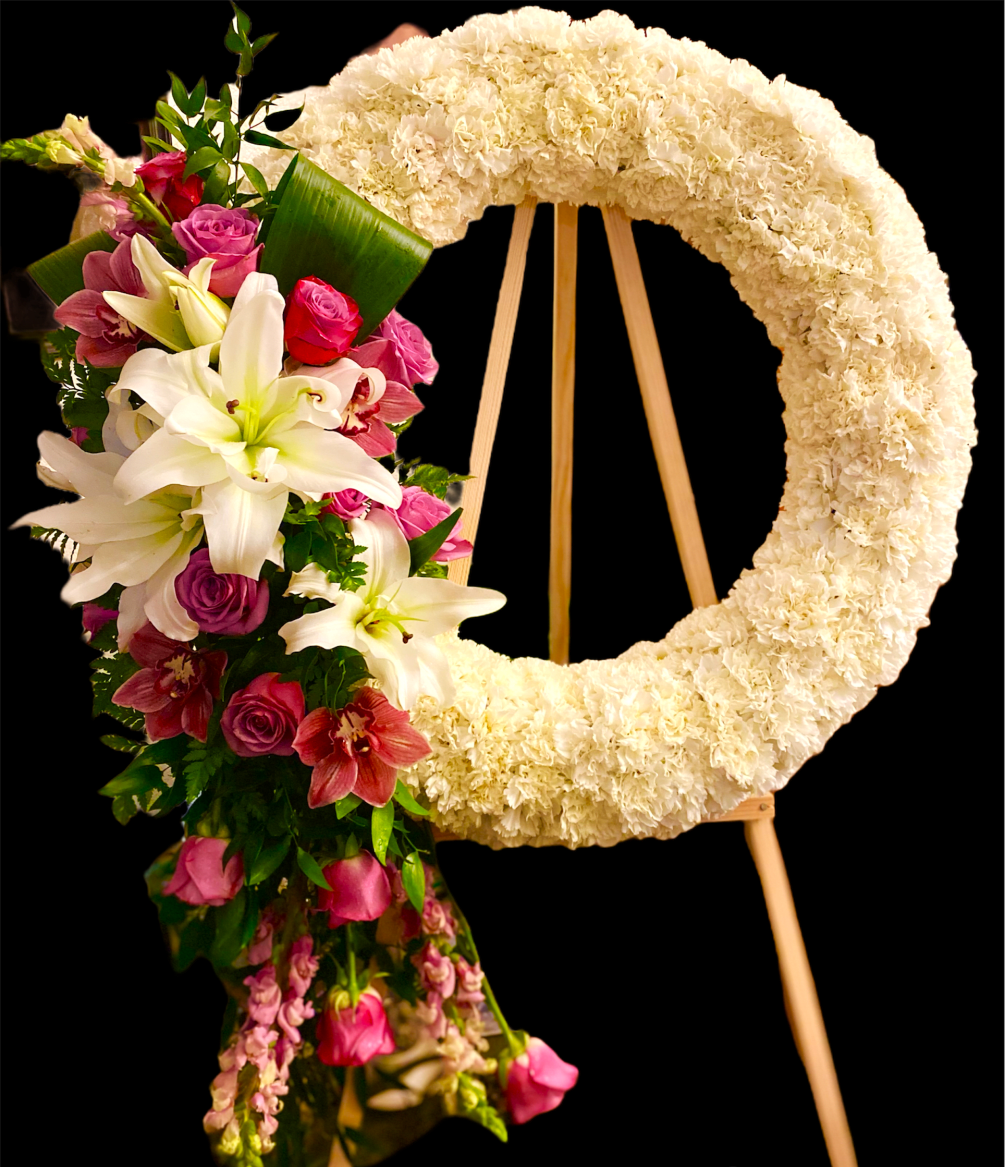 This beautiful sympathy wreath is composed of various blooms in shades of