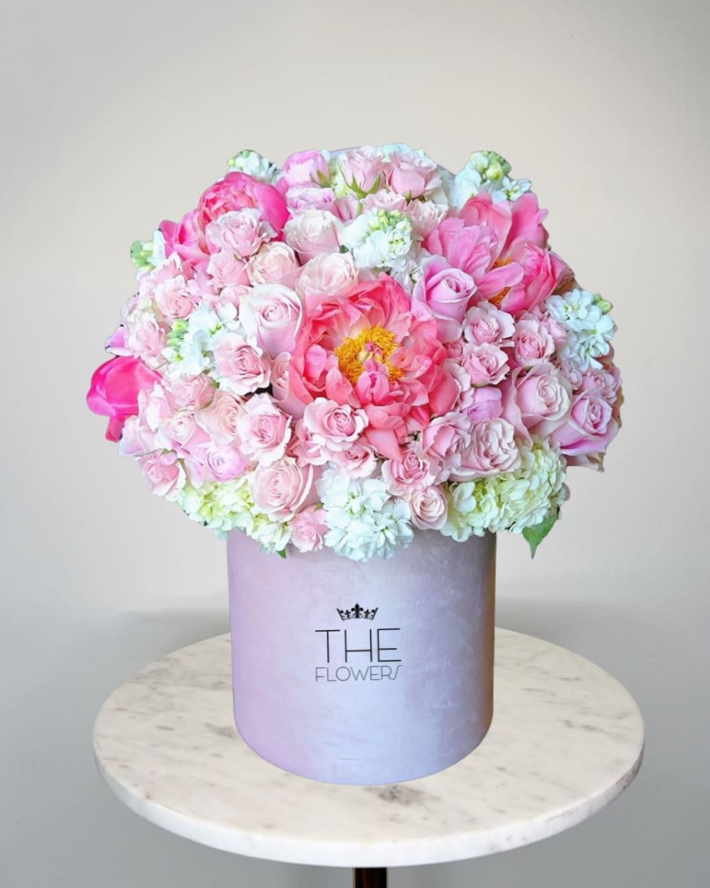 Admires the harmonious combination of coral peonies Coral Sunset and pink roses.
