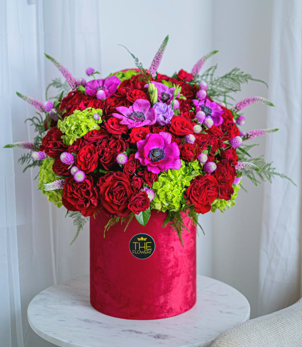 This arrangement in a hatbox in a red palette is a composition