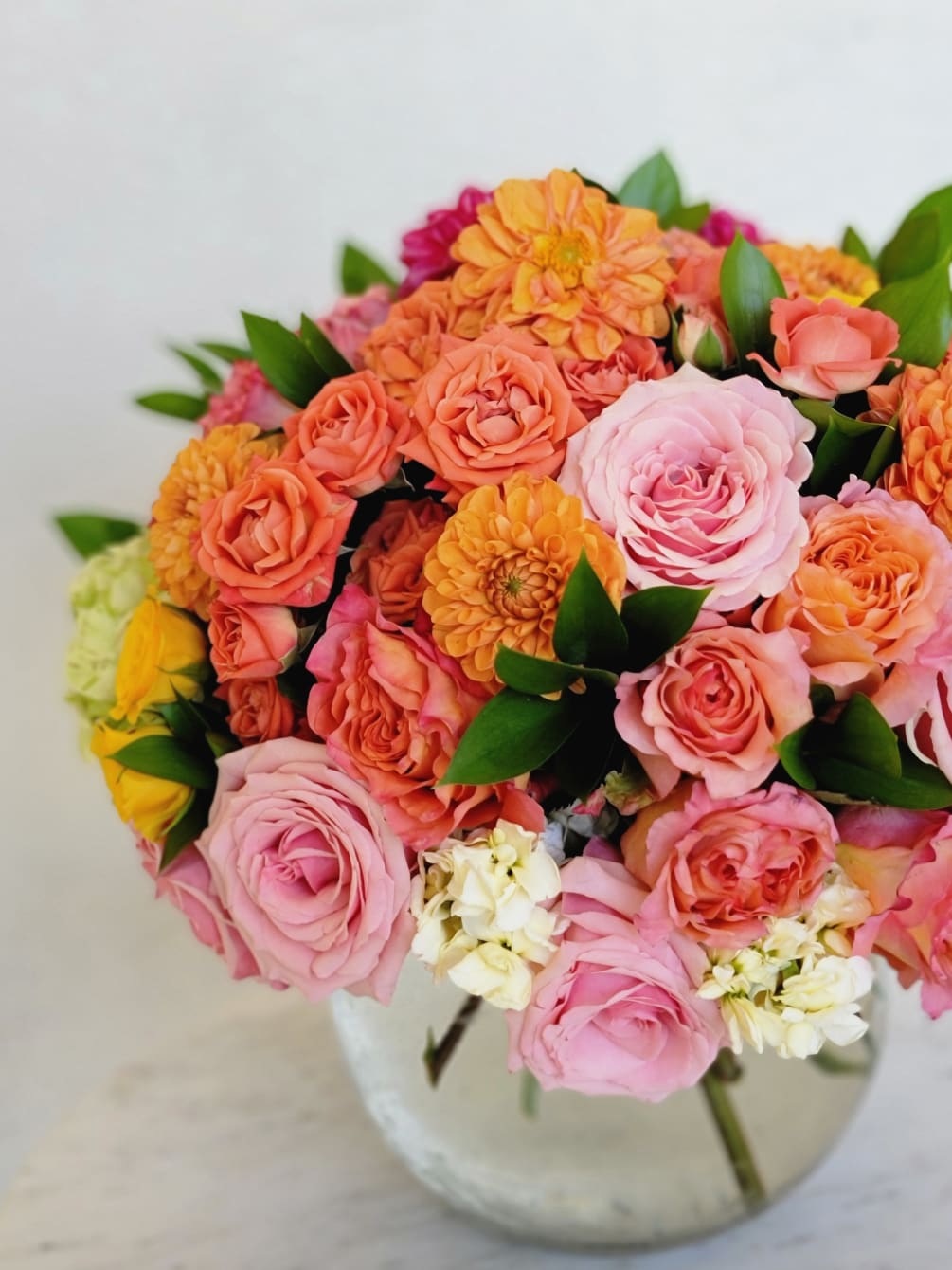 The combination of orange and pink roses looks beautiful and fresh! 
Such