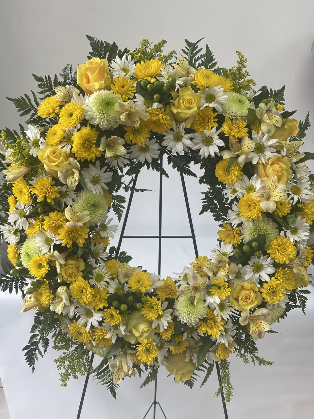 Funeral Wreath with mixed yellow and white flowers. 