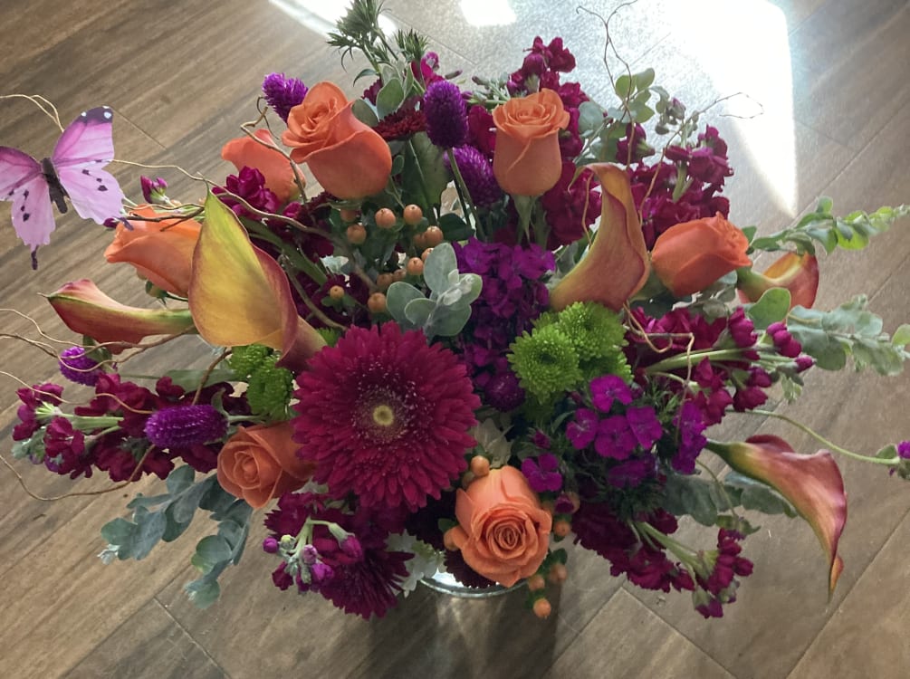 Bright colorful bouquet, with seasonal flowers in the colors of orange, purple