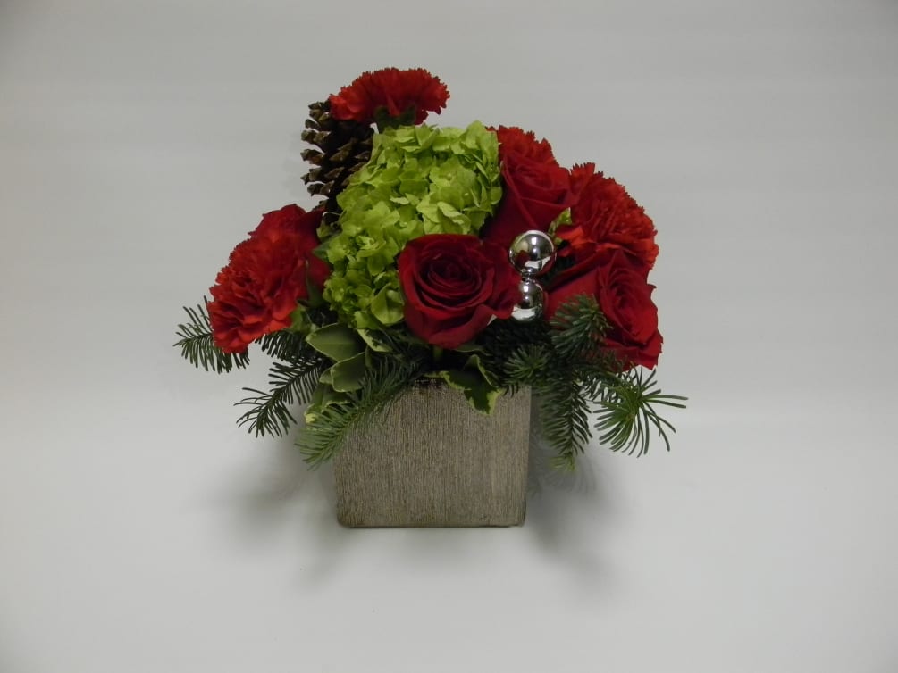 a silver cube filled with fragrant winter greens, lime hydrangea with red