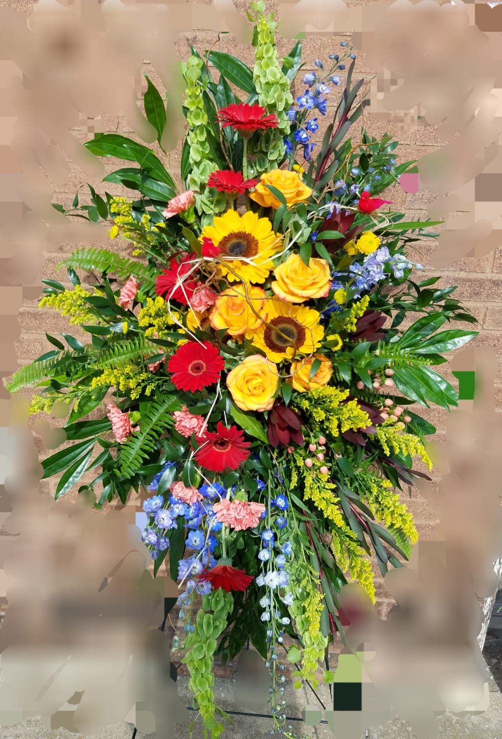 This easel spray is filled with the season&#039;s finest flowers.
*Flowers and colors