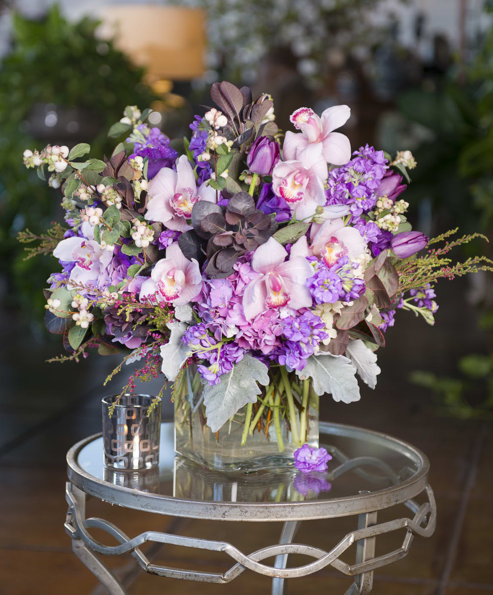 A mix of cymbidium orchids, stock, hydrangea, snowberries, stock, dusty miller and