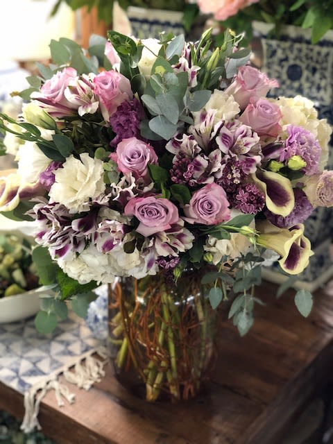 A beautiful assortment of purple, lavender and white florals to include lisianthus