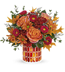 This beautiful bouquet includes orange roses, red matsumoto asters, bronze cushion spray