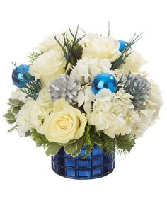 White roses and snow white carnations are decorated with silver pinecones arranged