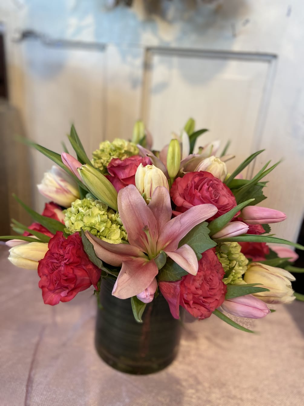 A lush collection of lilies, roses, tulips and hydrangea...guaranteed to make her