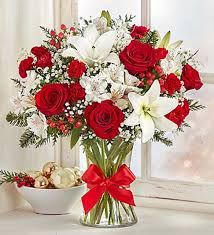 Lush vase of red and white flowers