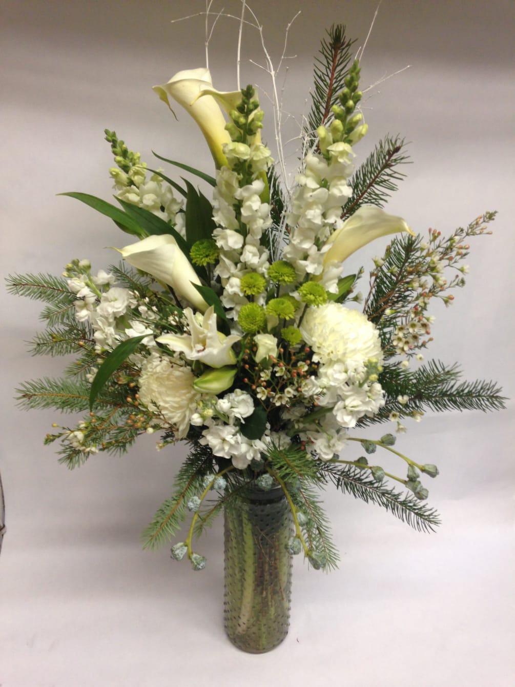 This winter inspired arrangement comes complete with mums, calla lilies, stock, snapdragons