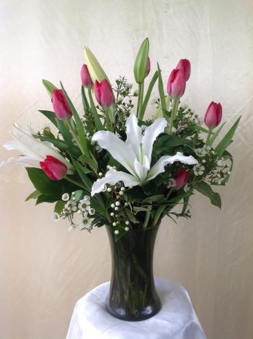 Tulips and lilies arranged with fillers 

