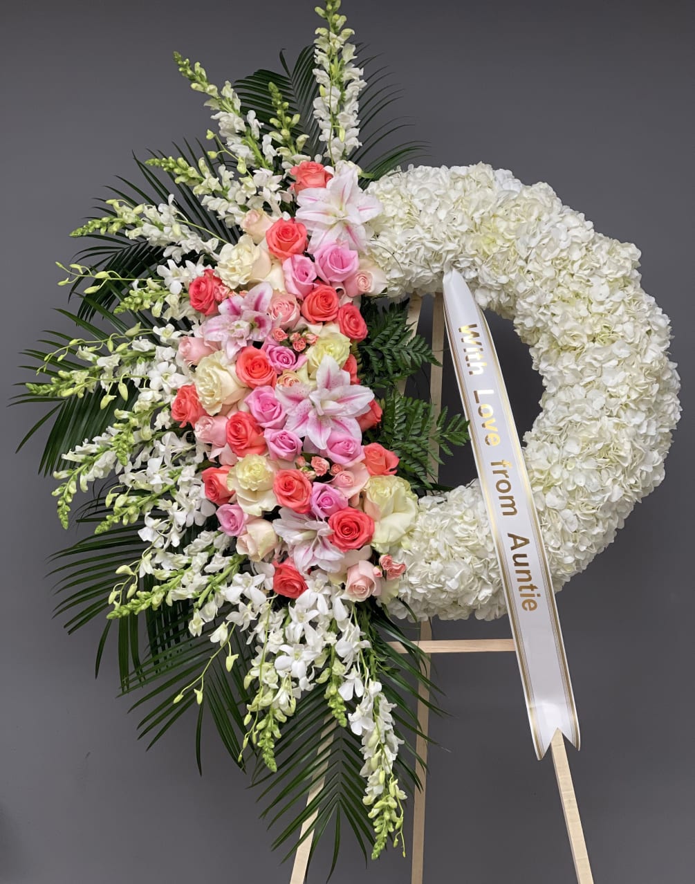 A wreath sympathy flower arrangement is a circular arrangement of flowers that