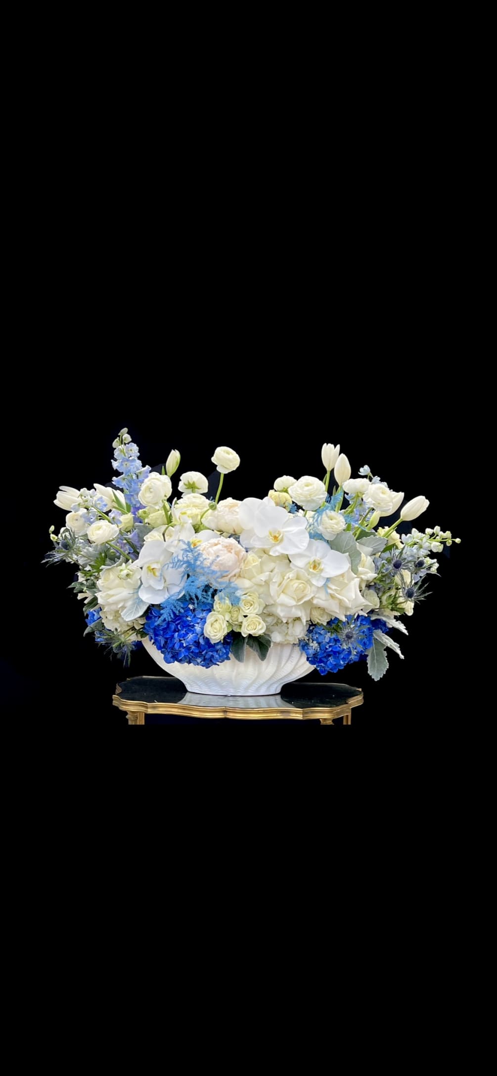 Pink roses, tulips, orchids, white and blue hydrangeas.... This arrangement is a