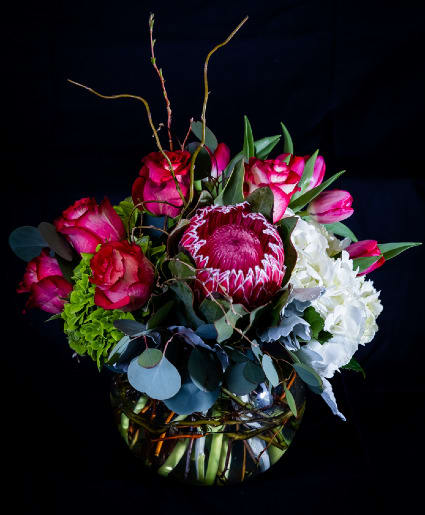 Fish bowl with white and green hydrangea , pink roses and pink