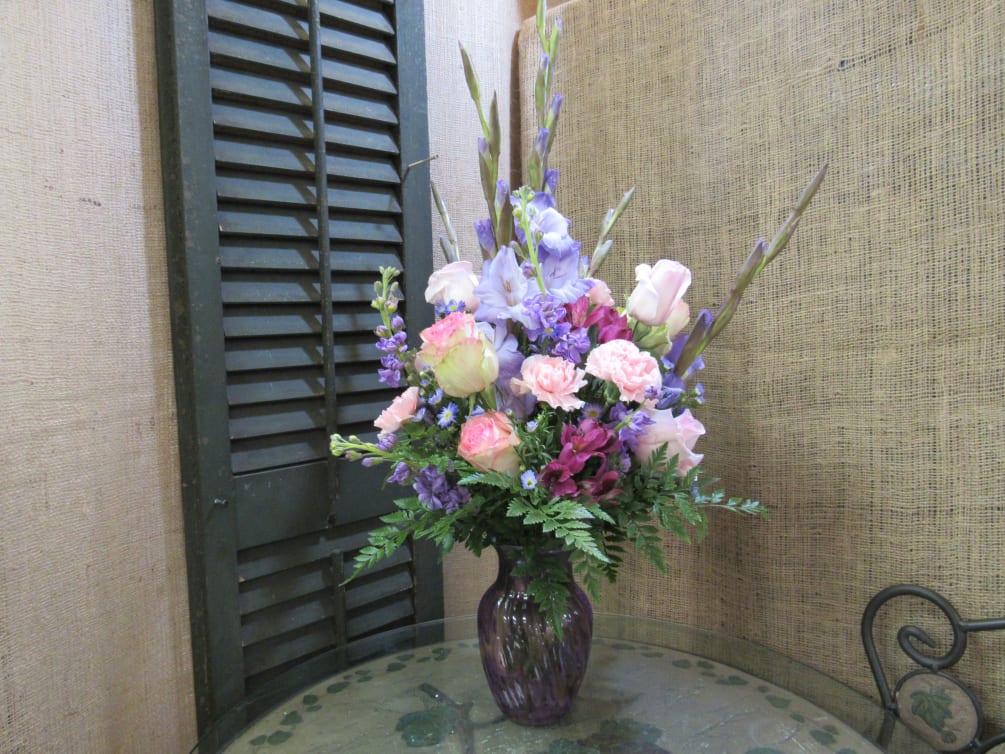 Purple and pink flowers in a vase.
