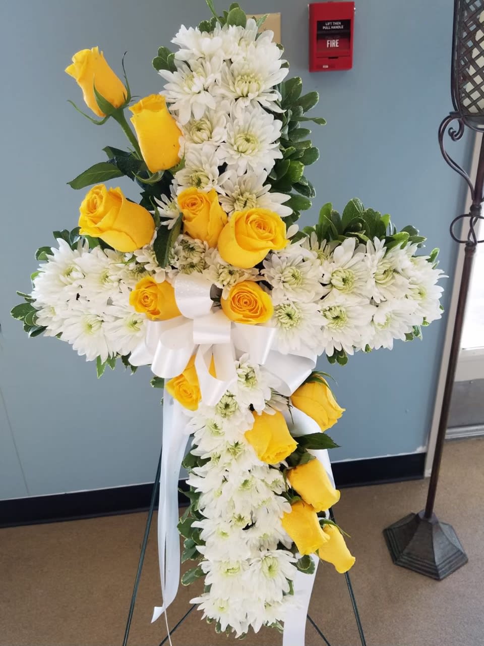 With with yellow roses standing cross