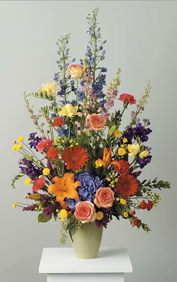 This colorful blend of seasonal garden flowers is ever-changing! We use the
