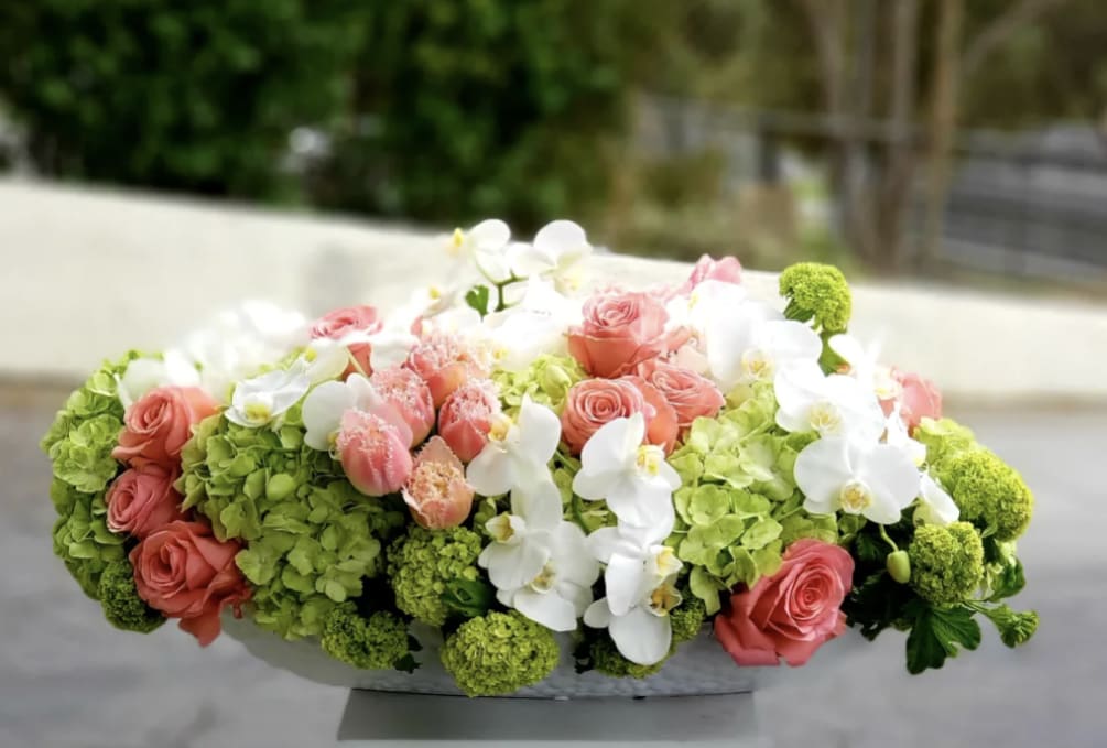 This large and gorgeous arrangement made of roses, hydrangeas, orchids, and beautiful
