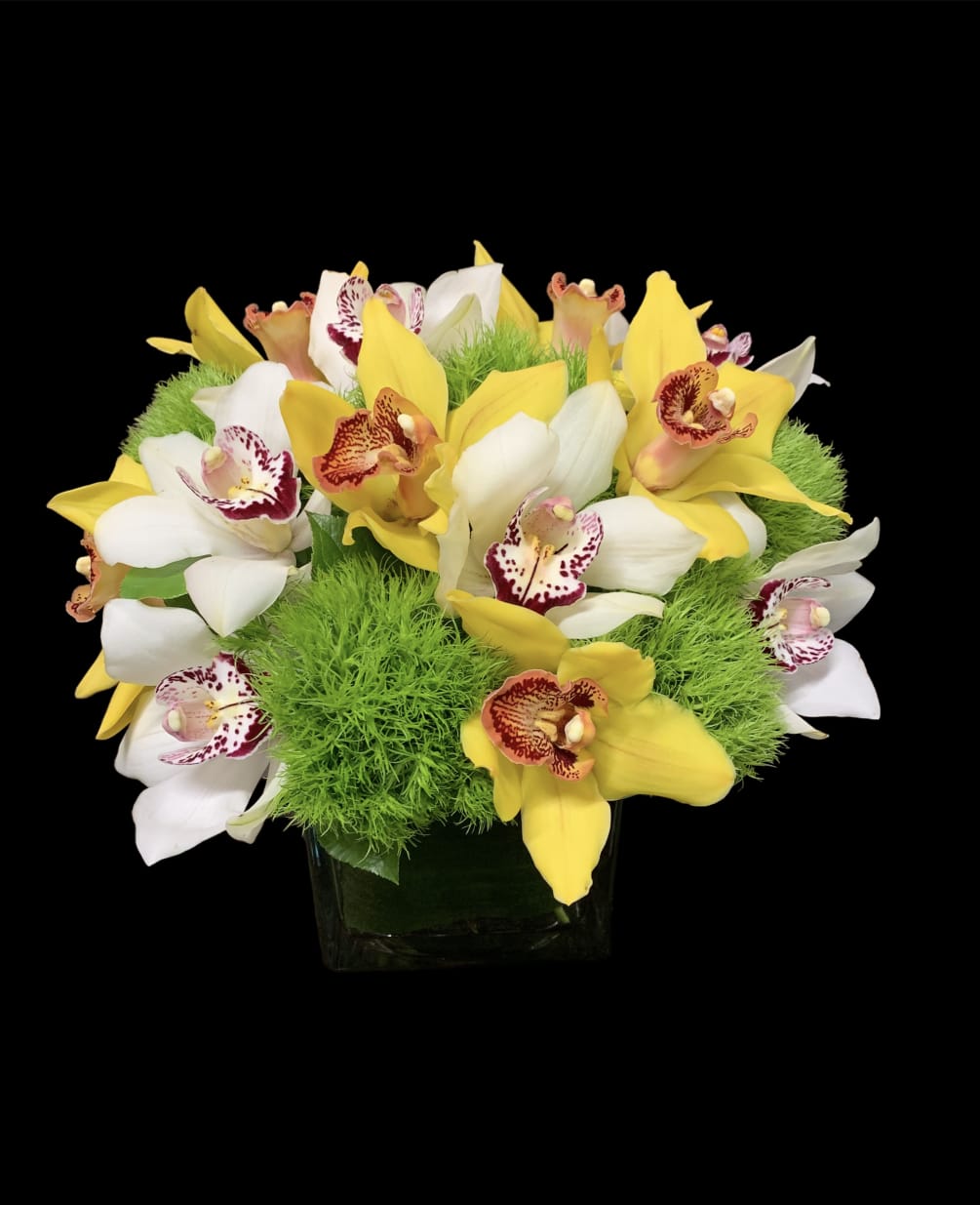 A beautiful arrangement with yellow and white orchids with dianthus 