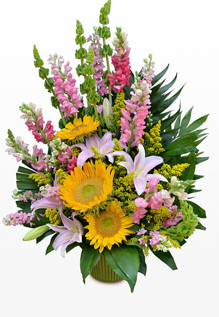 Large floral arrangement of Vibrant sunflowers, pink snapdragons, white lilies, solidago, bells