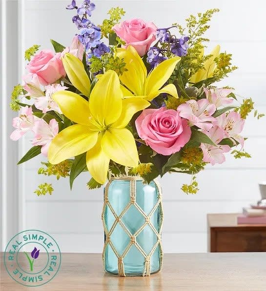 Light pink roses, yellow lilies, light blue delphinium and pink alstroemeria make