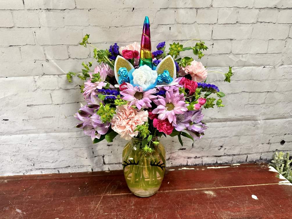 Fresh glimmering flowers in unicorn vase. Made extra special with colored water