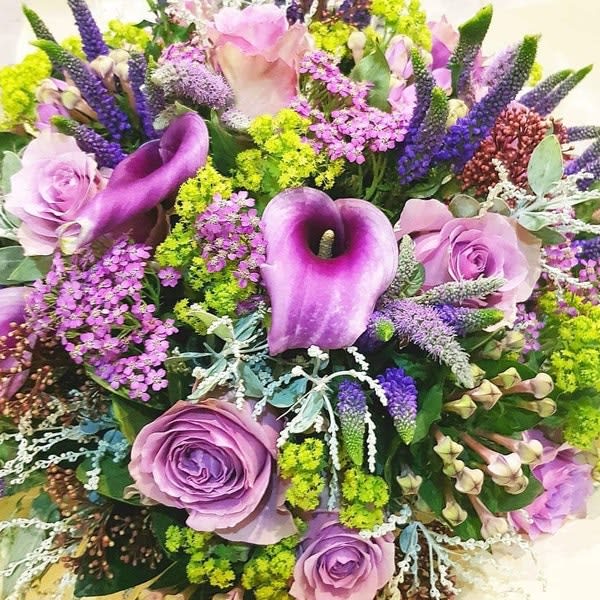 Best available selection of seasonal flowers in shades of purple and green.