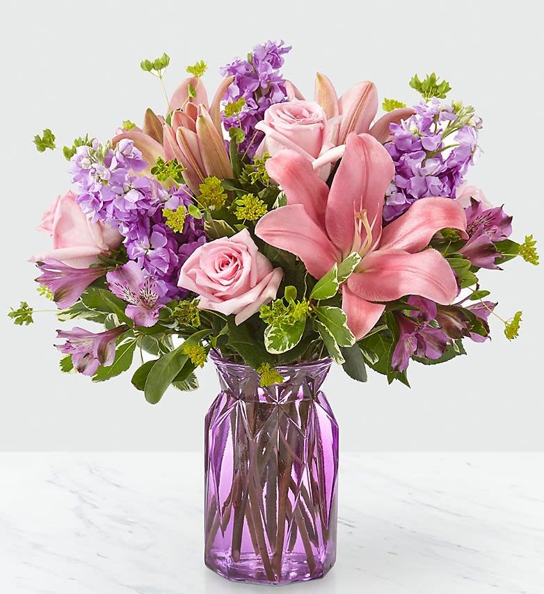 Pink lilys, pink roses, lavender stock and more come together in this