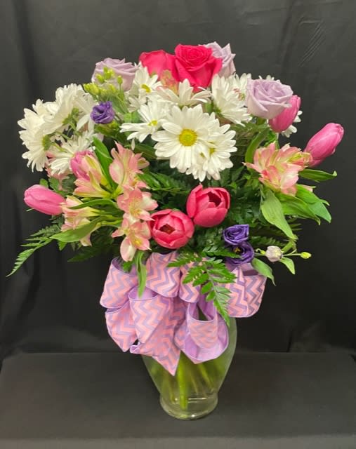 Mixed cut arrangement with pink tulips, white daisies, lavender roses, hot pink