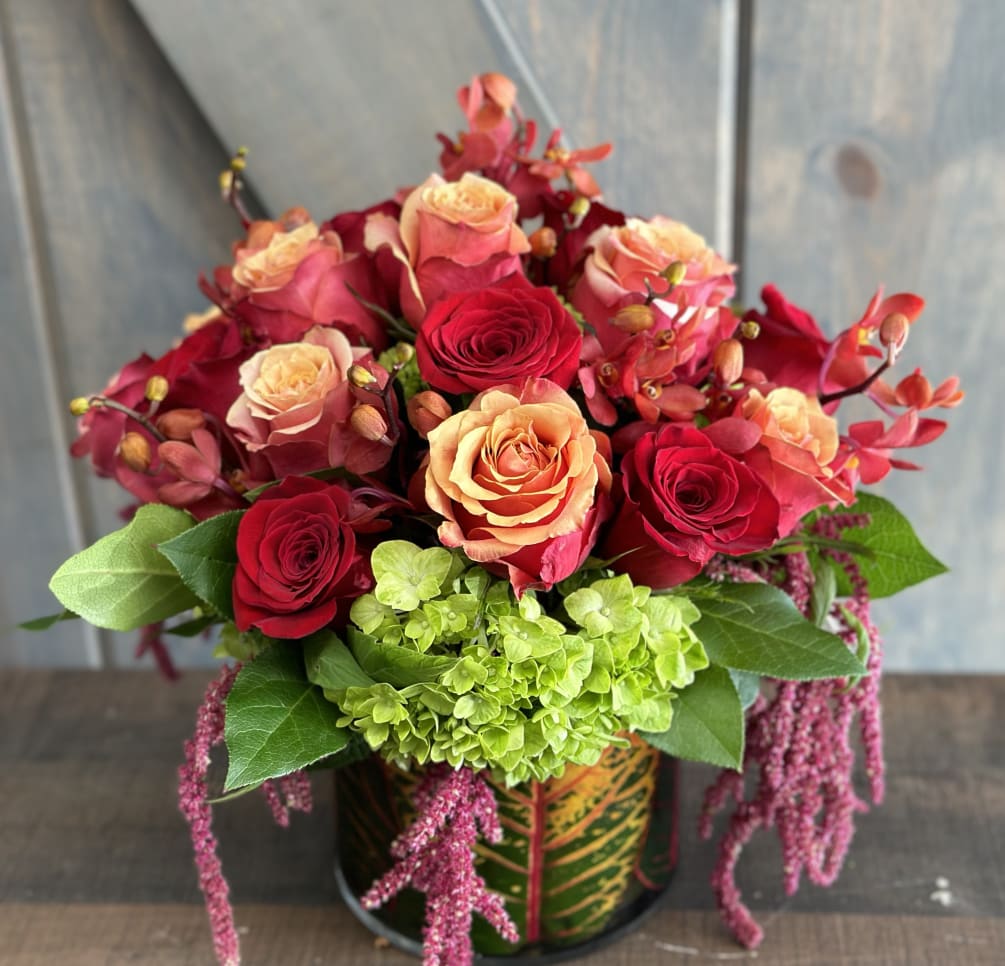 A Luxurious mixed of Roses, Orchids, Hydrangea, Hanging Amaranthus and Croton leaf.