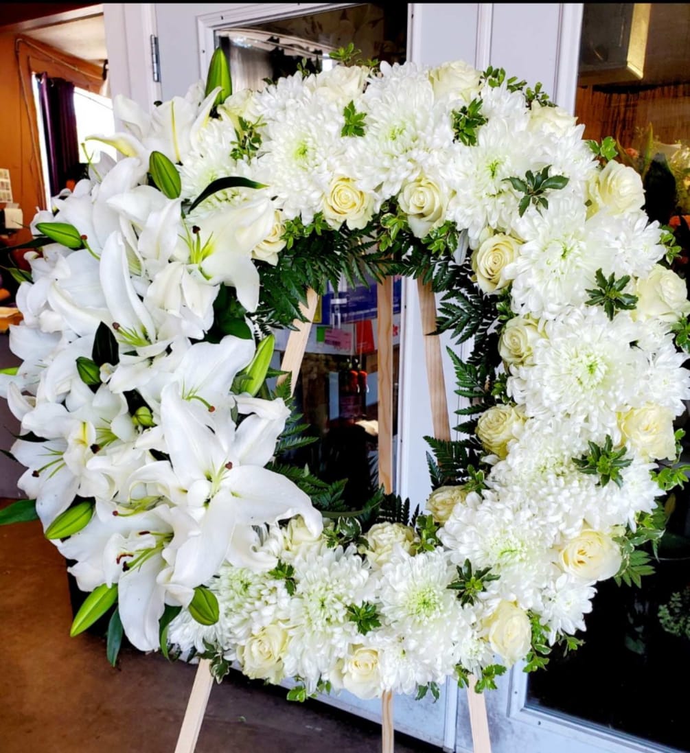 All White Wreath made with white mums, roses and lilies accented by