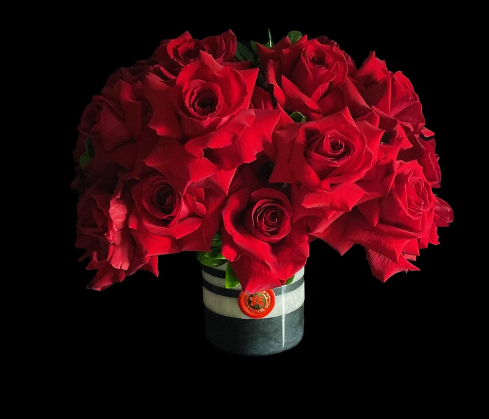 Red Roses on sliced black and white marble vase and foliage.