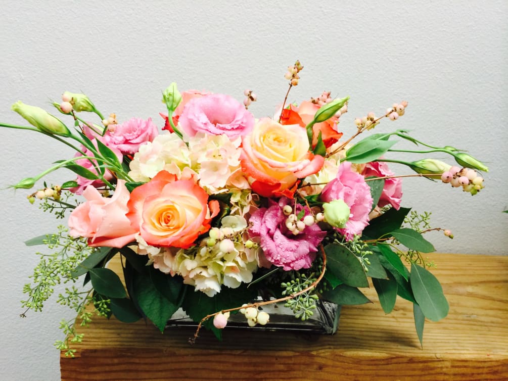 A mix of peach and pink roses and white hydrangeas. 
