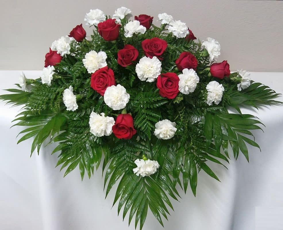 This casket spray is made with roses and carnations in the color