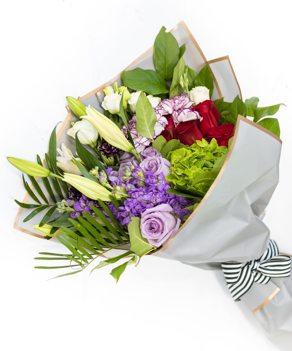 Hand-delivered romantic blooms wrapped in decorative Kraft paper to enjoy yourself or